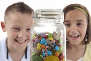 Girl & boy looking at sweet jar