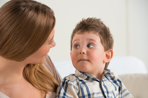 Happy mother talking to her son at home