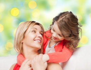 mother with daughter hugging and talking