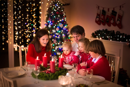 Family having Christmas dinner at fire place