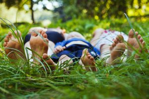 family relaxing on the grass