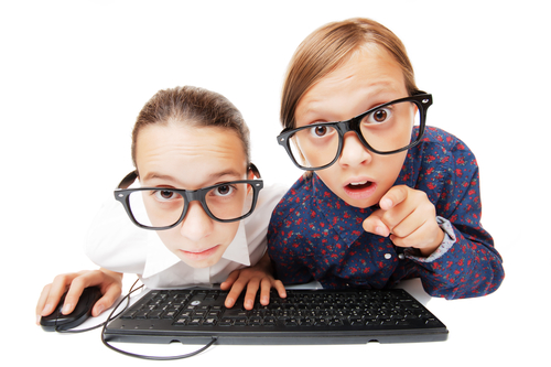 Young girls playing or working on a computer