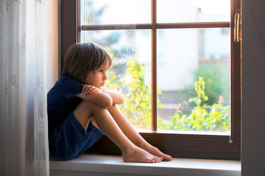 sad boy at window