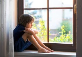 sad boy at window