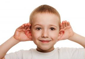 boy holding ears